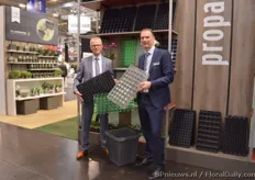 Kees Waque and Pascal Rossen of Desch Plantpak presenting three of their novelties; a new orchid tray (the one Rossen is holding), paperpot tray (the one Waque is holding) and the Aqua Max (the container on the floor).