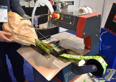 The machine binds the bunch and directly adds the flower food sachet to the bunch. The bunch still needs to be sleeved manually, but they are also working on a machine for that.